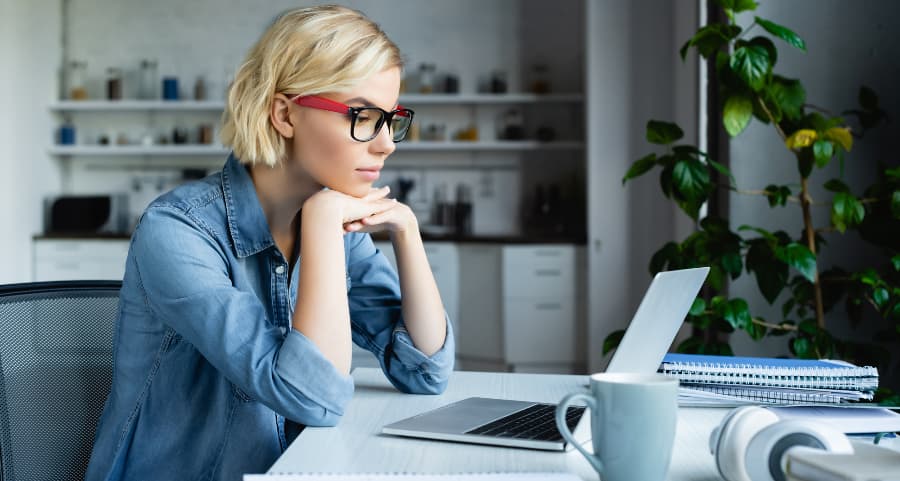 Remote worker using laptop in home workspace